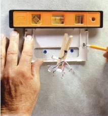 Level the new mounting plate on the wall and mark the fastener locations. Use drywall anchors and screws to secure the plate firmly.