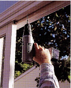 Top door track. Drive a couple of screws into the top track leaving the heads protruding so the door can't be lifted and removed from the outside.